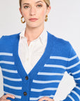 Woman wearing a blue and white striped cardigan on a plain background