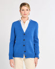 Woman in blue cardigan with white background. 