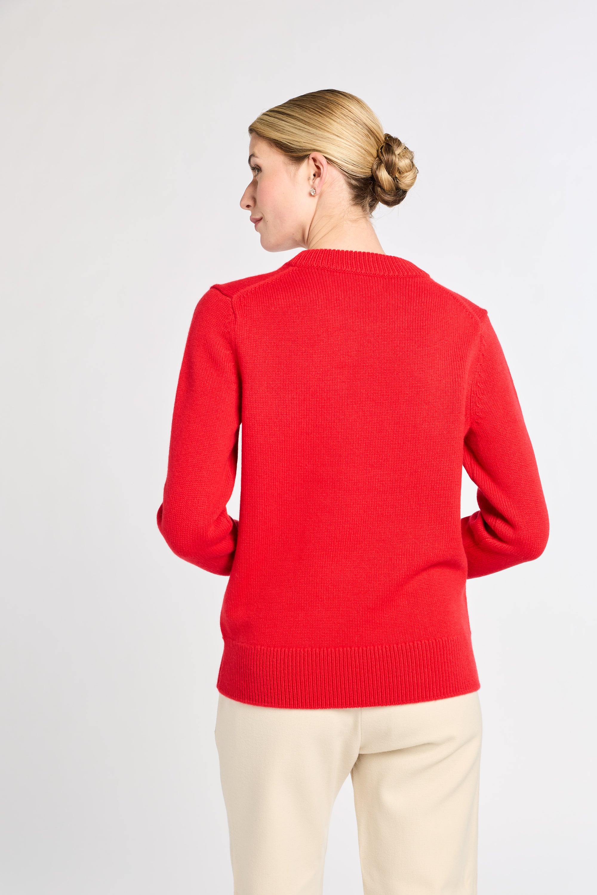 Person wearing a red sweater on a white background