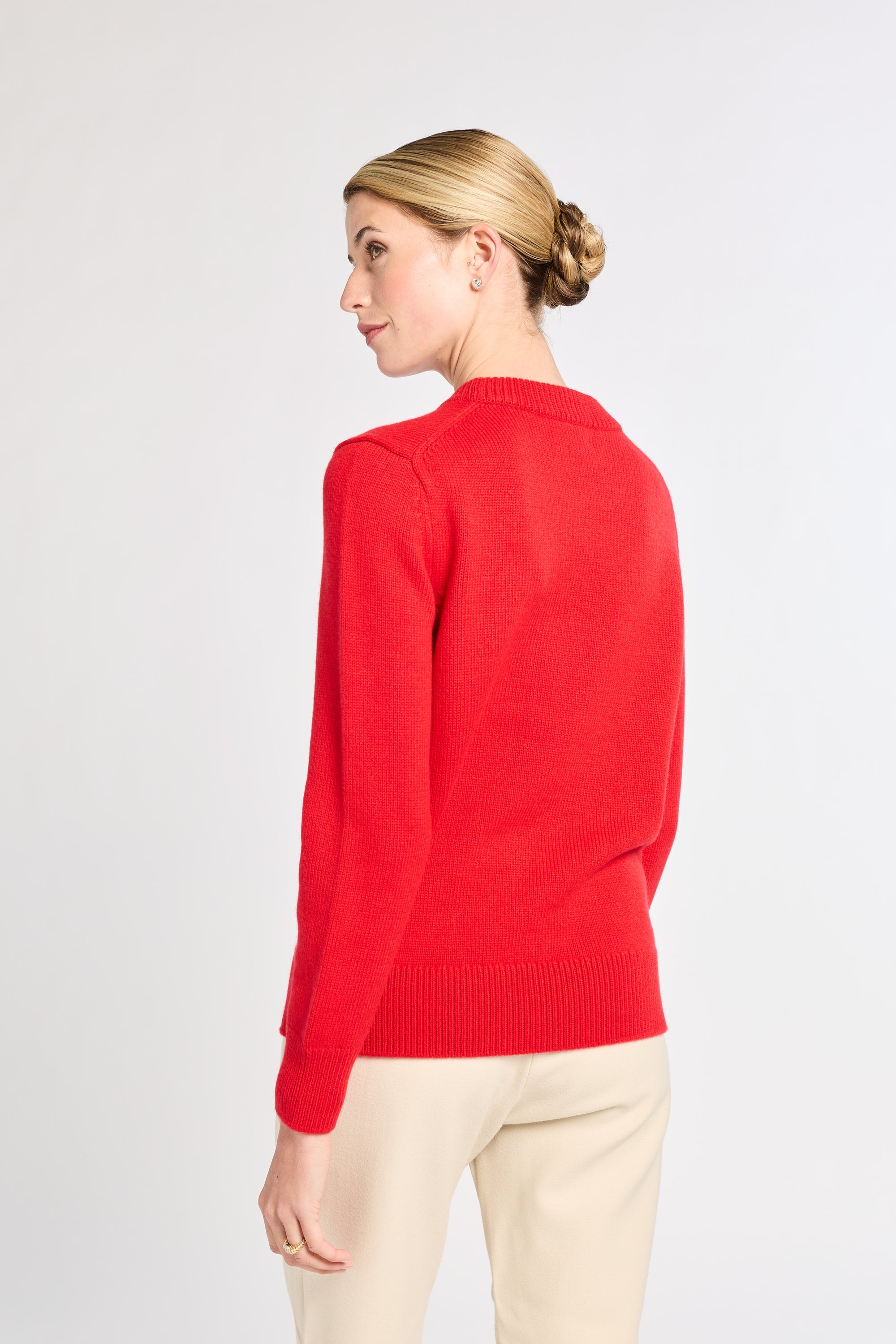 Woman wearing a red sweater on a white background