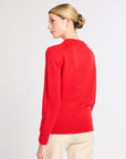 Woman wearing a red sweater on a white background