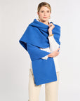 Woman wearing a blue wrap over a white background