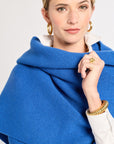 Woman wearing a blue shawl over a white background