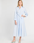 Woman with blue stripe dress with white background.