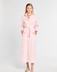 Woman wearing a pink dress against a white background