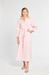 Woman wearing a pink dress with a belt on a white background