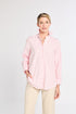 Woman wearing a light pink striped shirt and beige pants on a white background