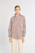 Woman wearing a striped shirt and beige pants on a white background
