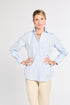 Woman wearing a light blue striped shirt and beige pants on a white background