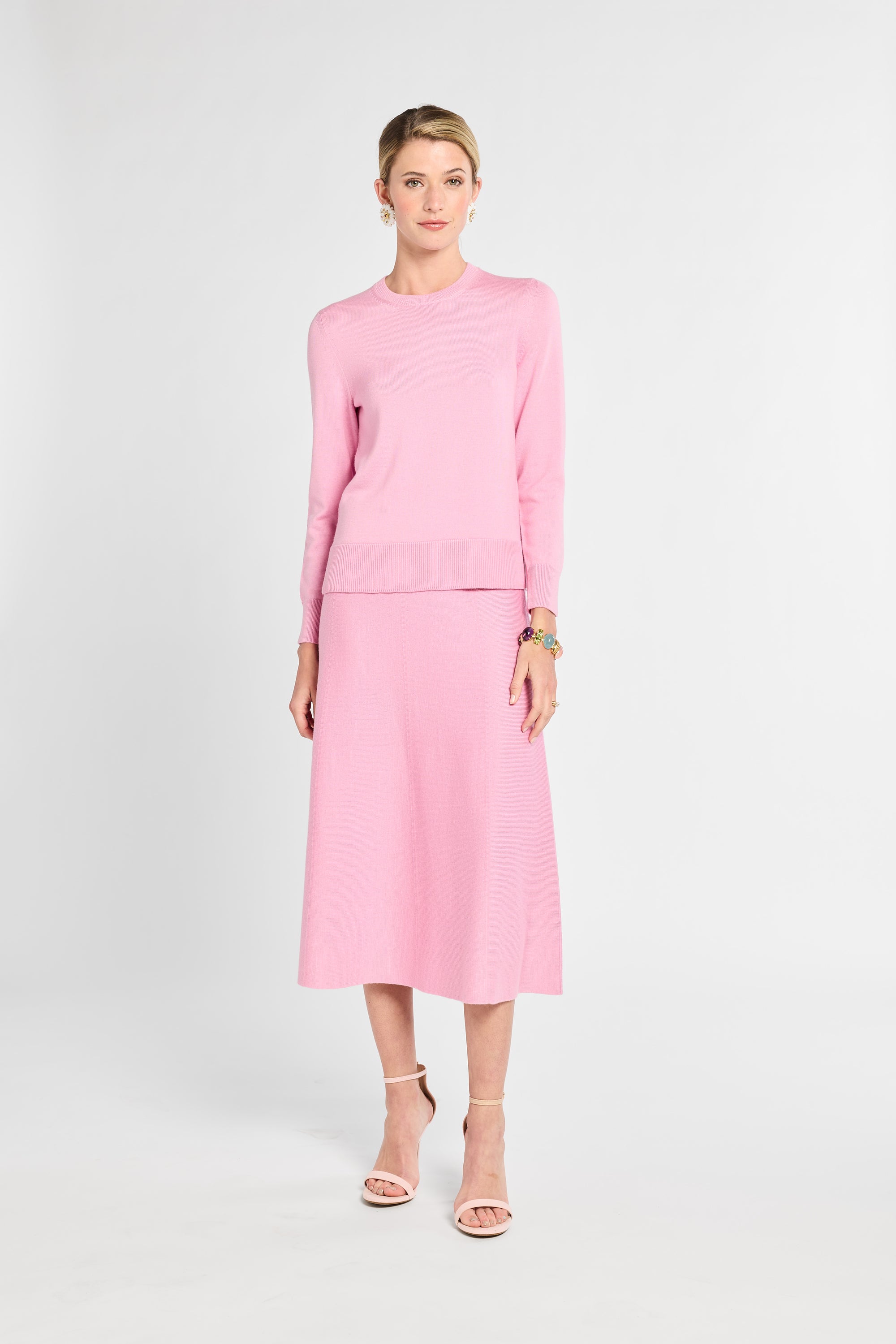 Woman wearing a pink outfit on a white background