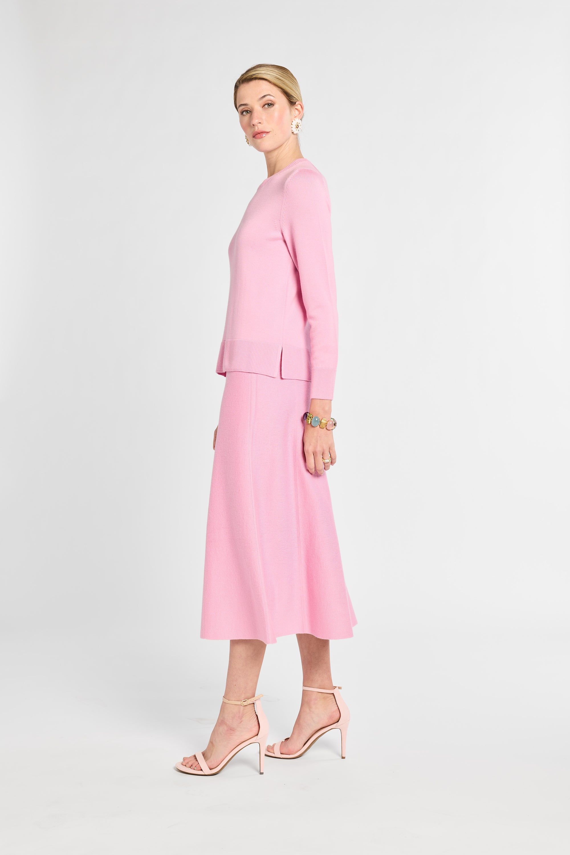 Woman wearing a pink suit on a white background