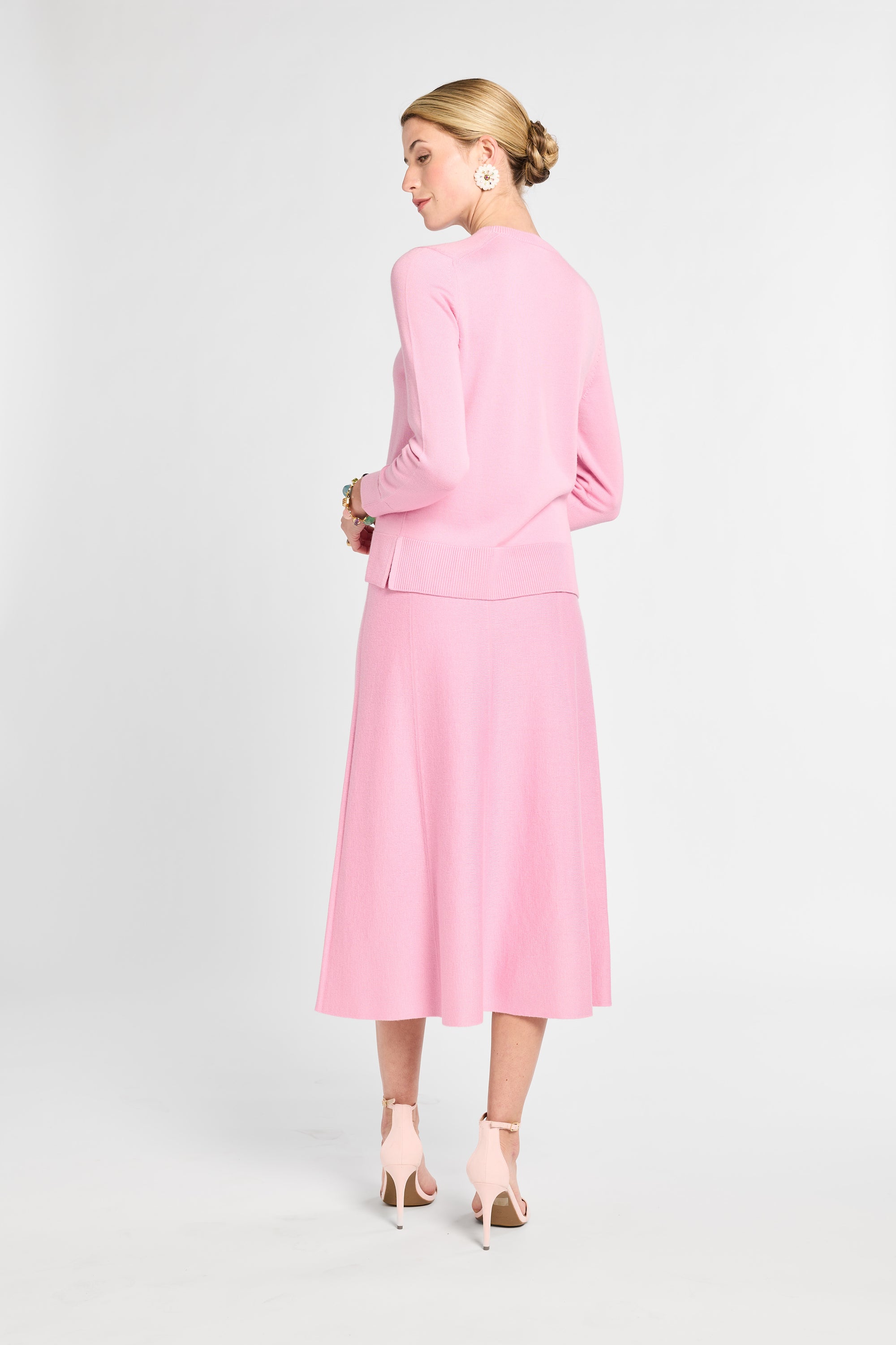 Woman wearing a pink suit on a white background