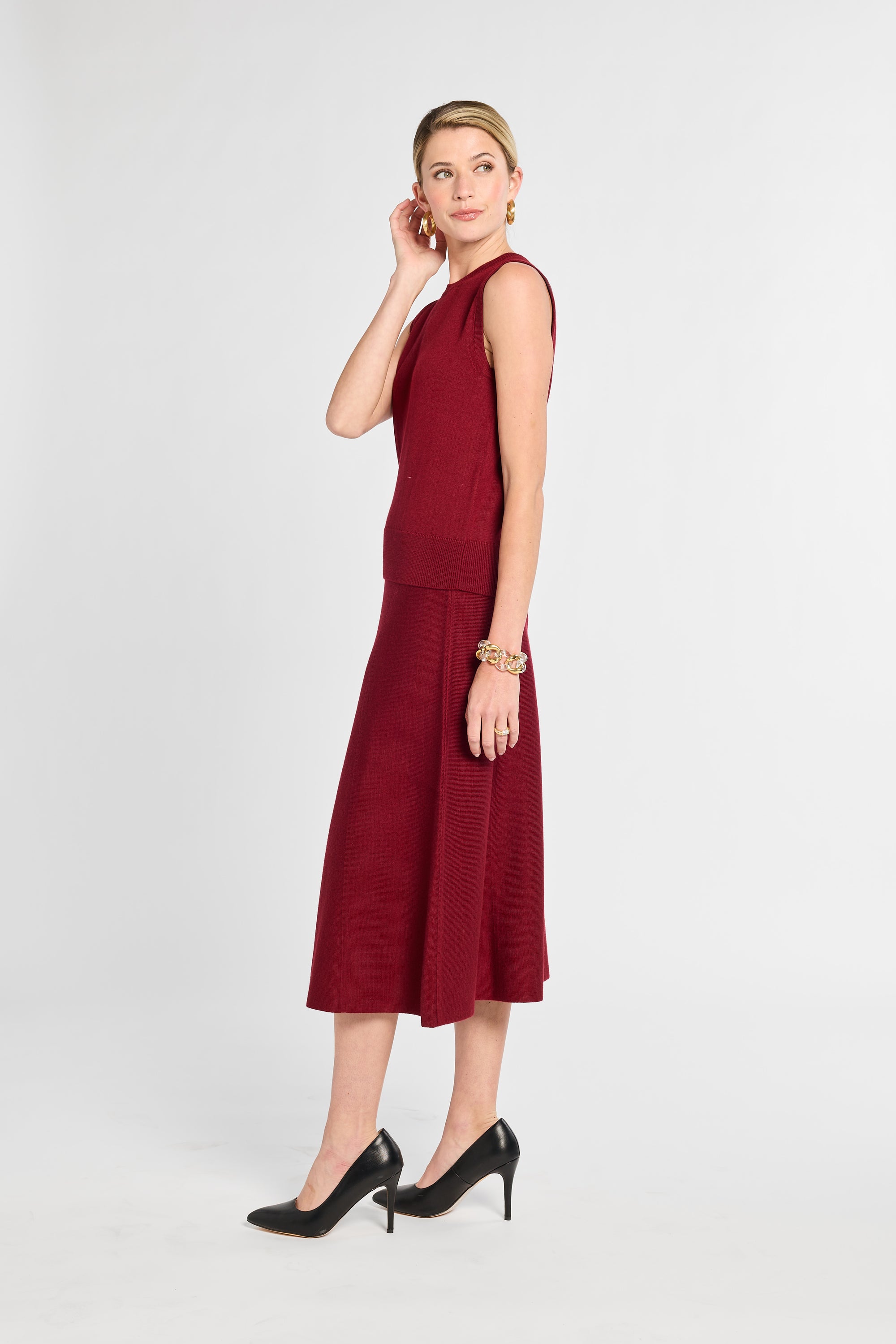 Woman wearing a burgundy dress on a white background