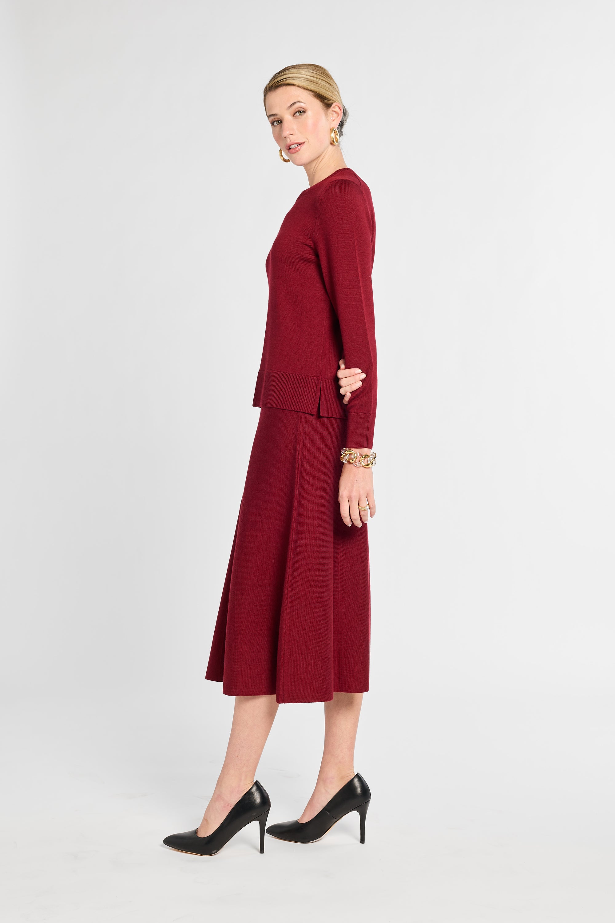 Woman wearing a burgundy suit on a white background