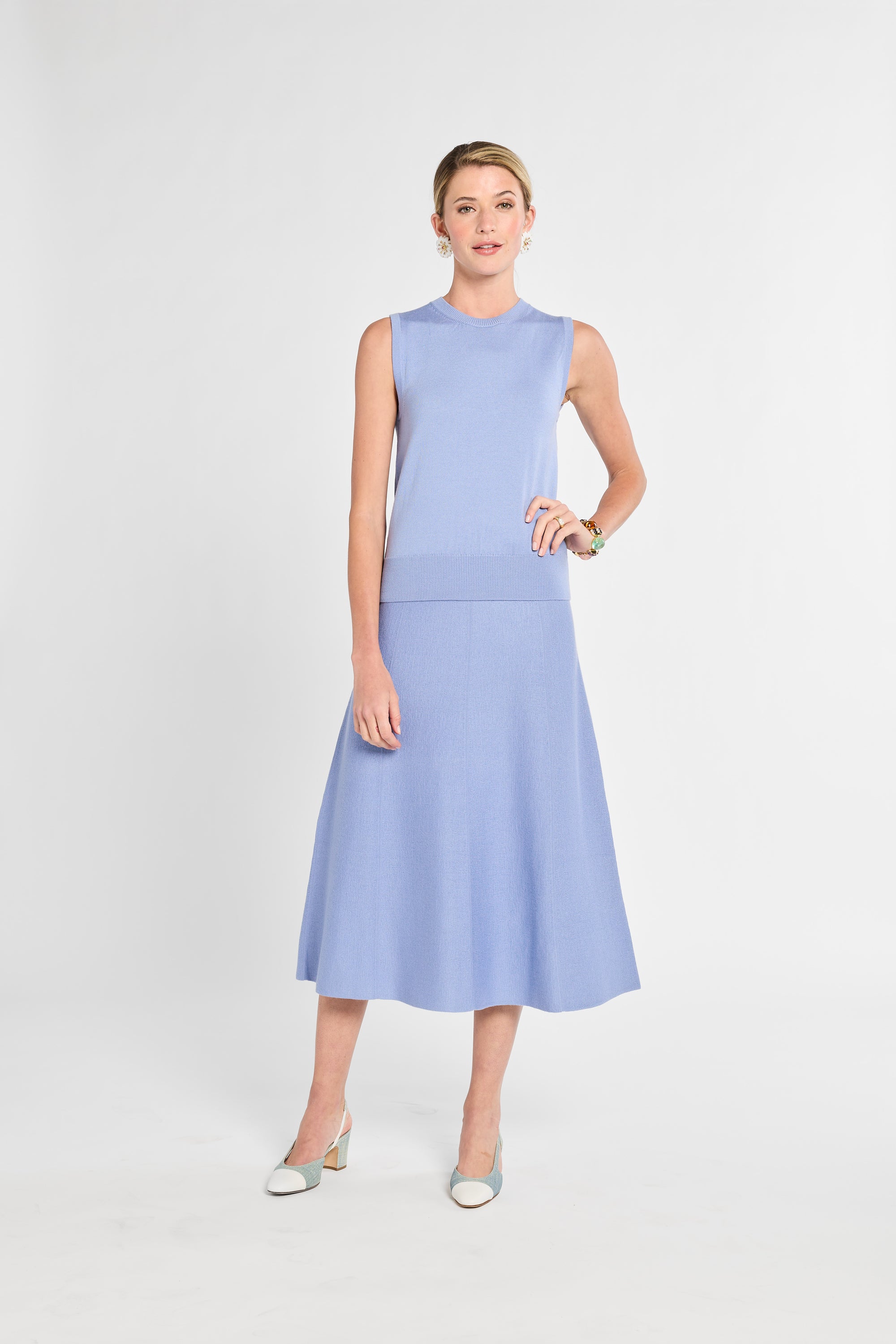 Woman wearing a light blue dress on a white background