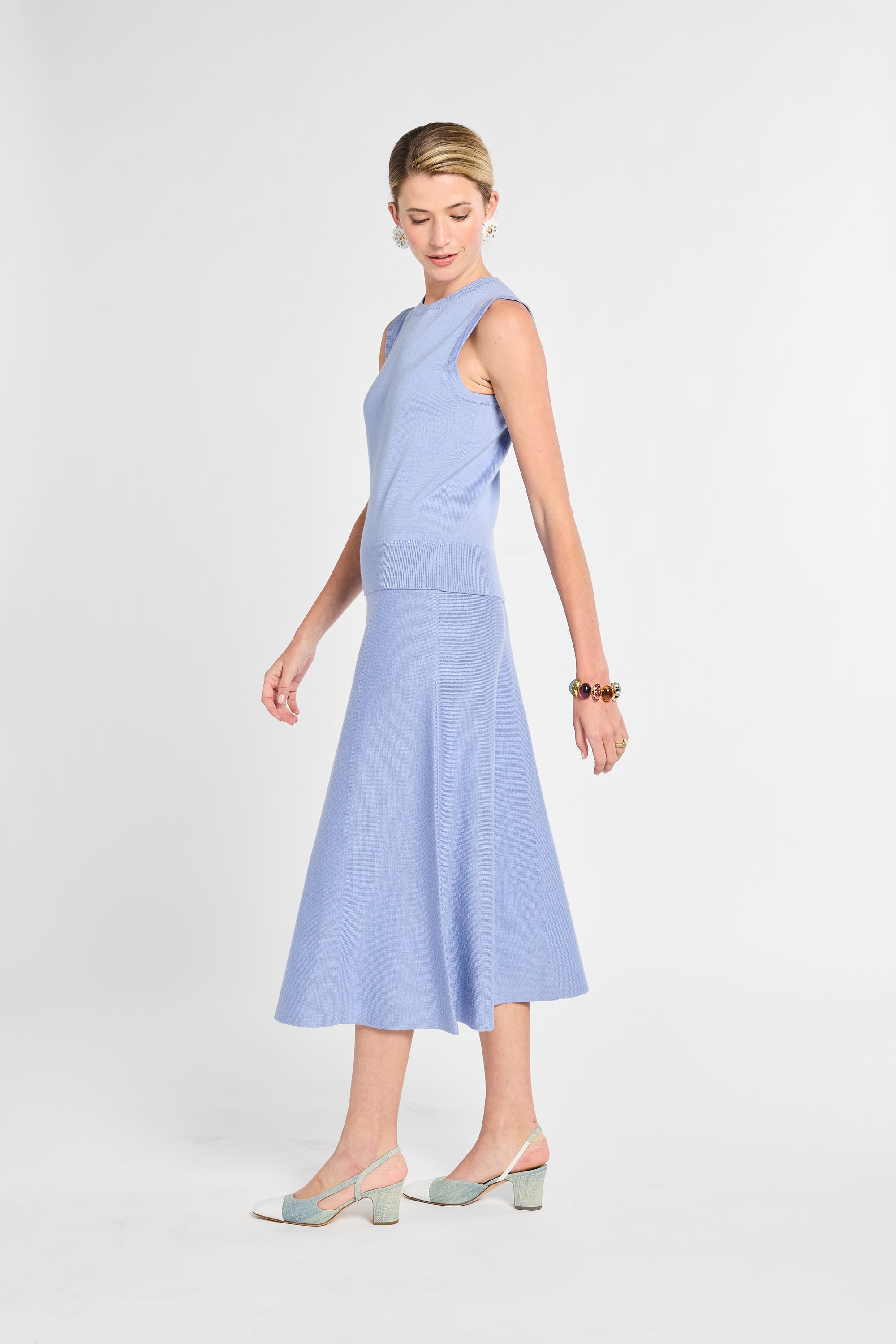 Woman wearing a light blue dress on a white background