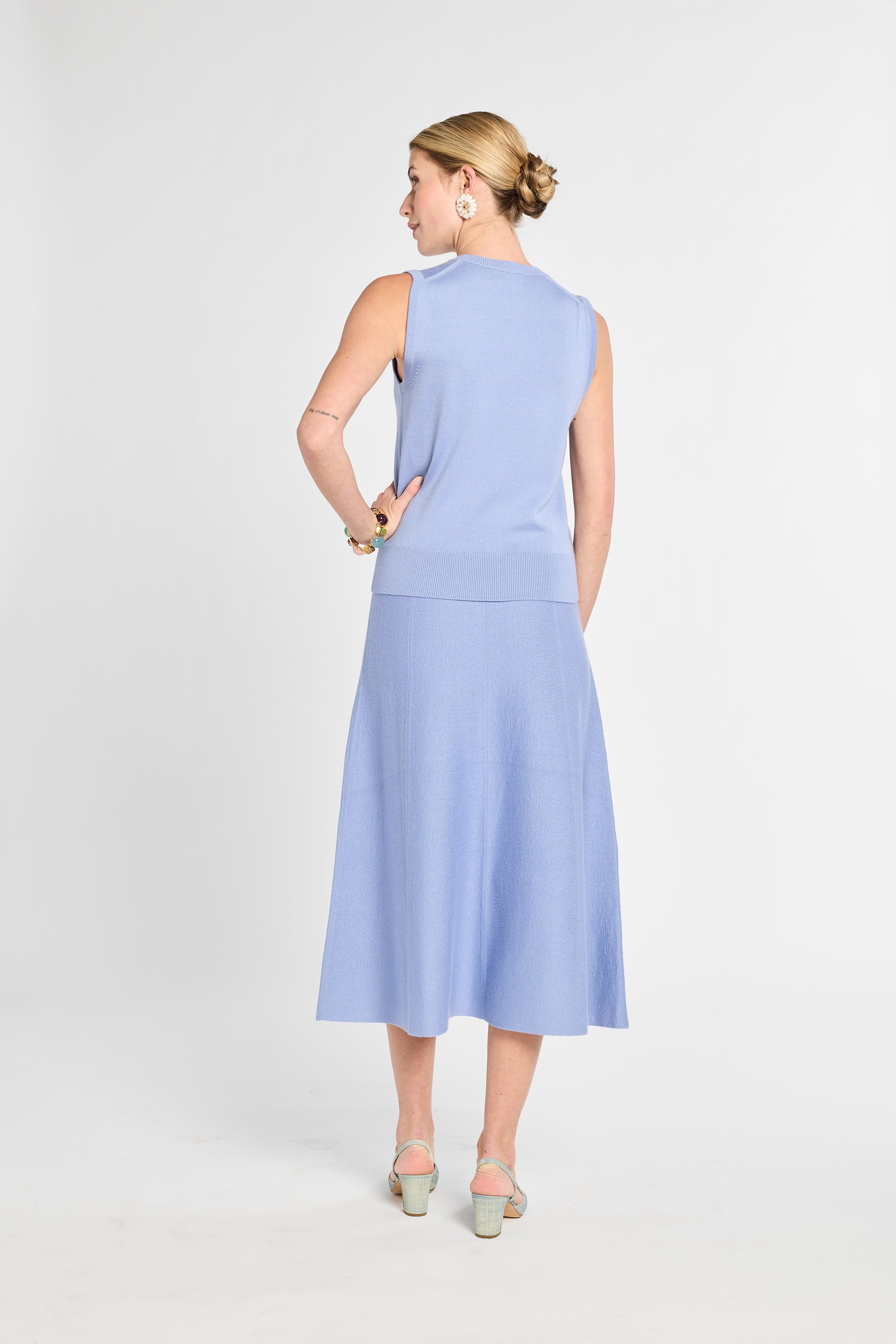 Woman wearing a light blue dress on a white background