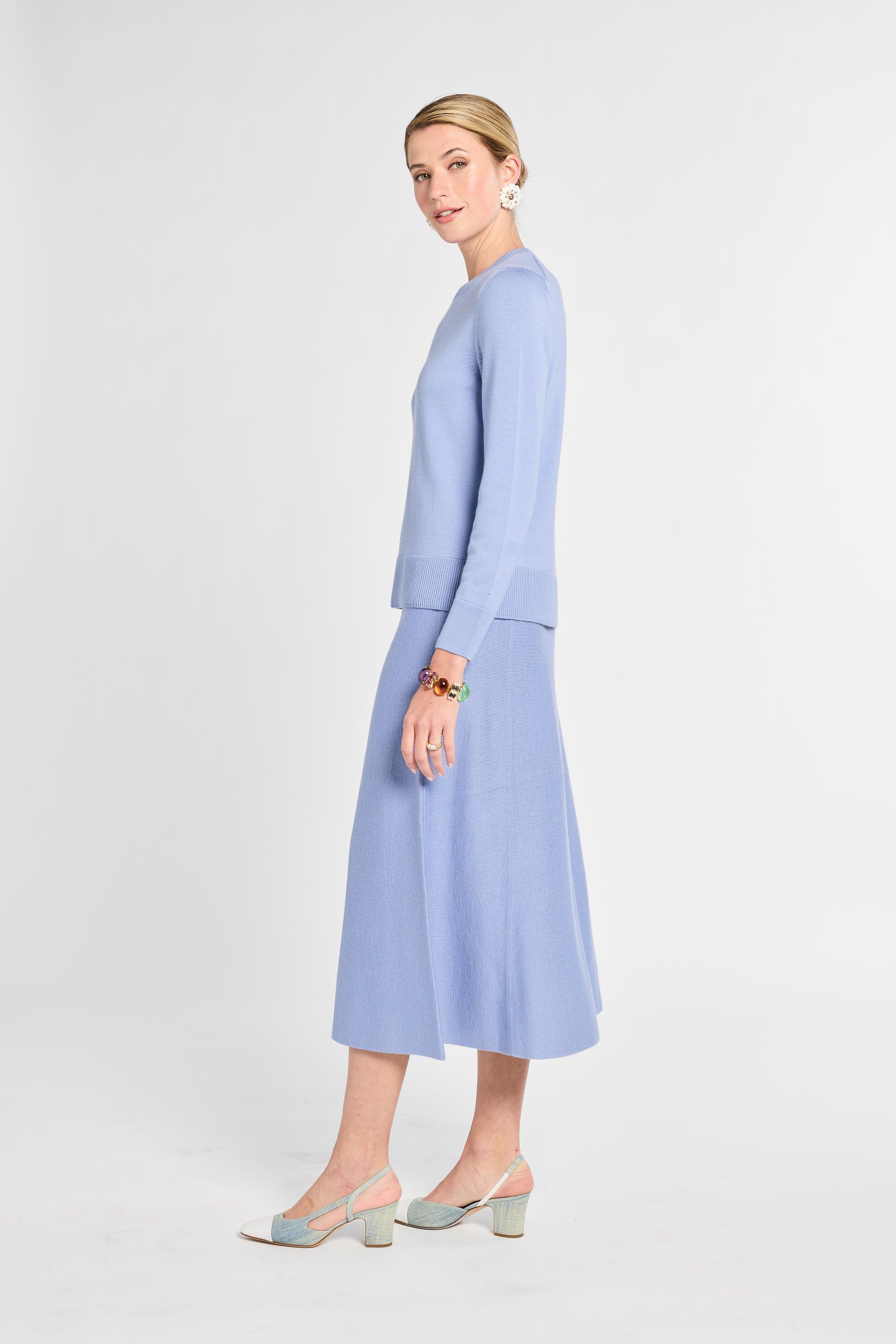 Woman wearing a light blue outfit on a white background