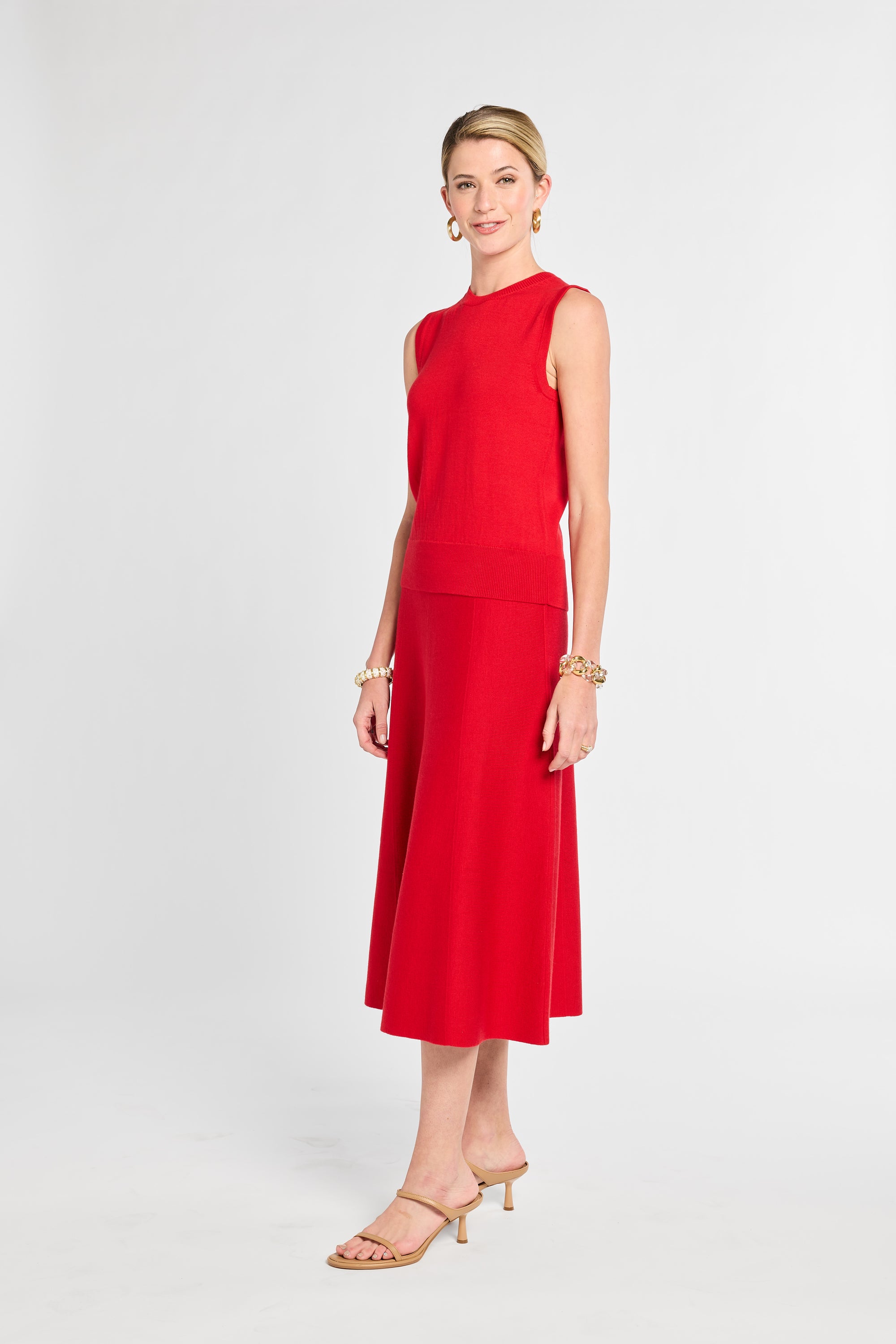 Woman wearing a red sleeveless dress on a white background