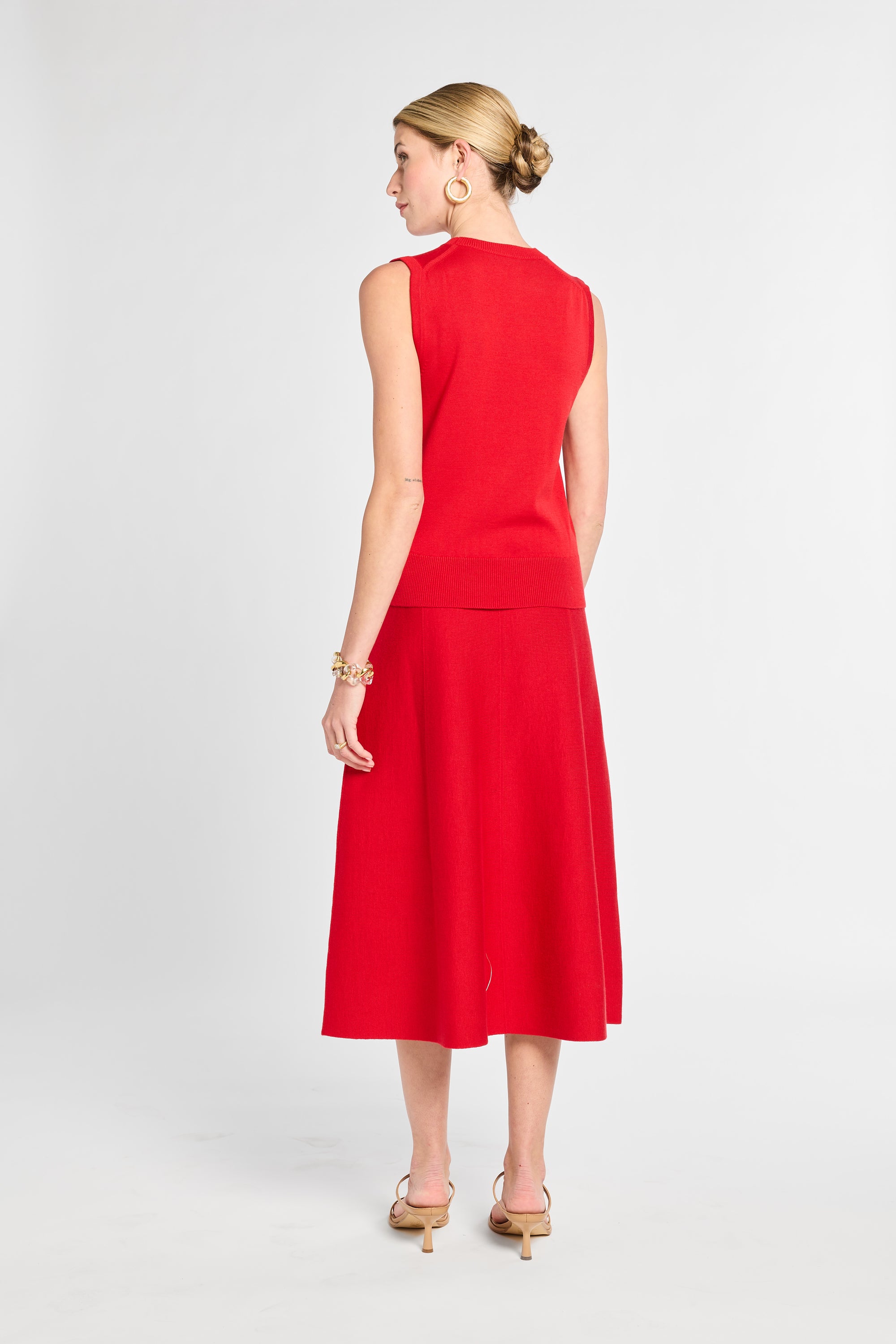 Woman wearing a red dress on a white background