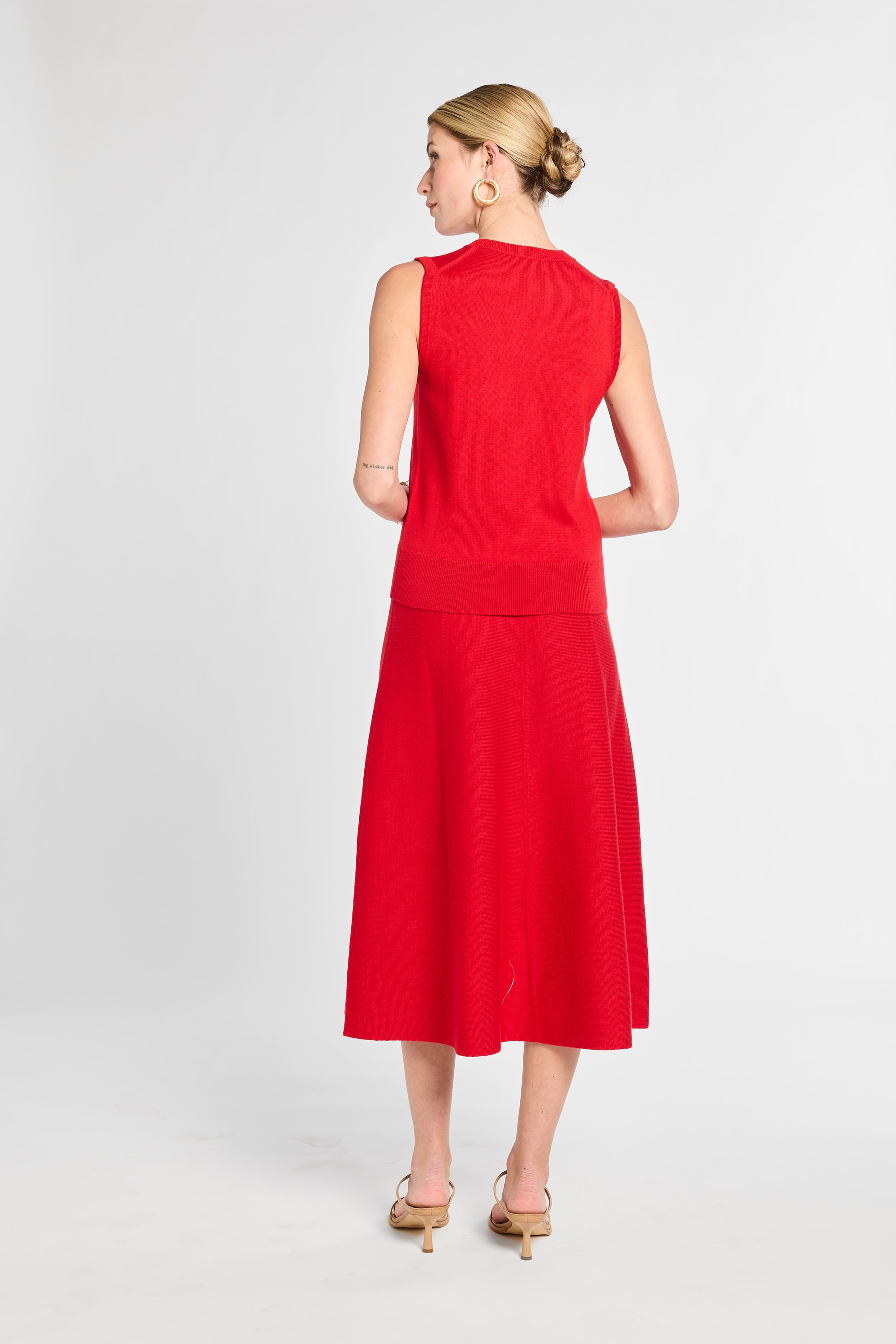 Woman wearing a red dress on a white background