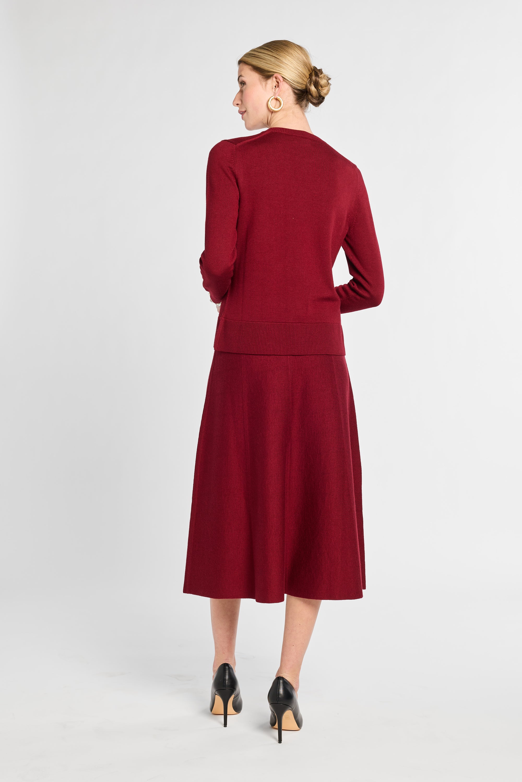 Woman wearing a red dress with a white background