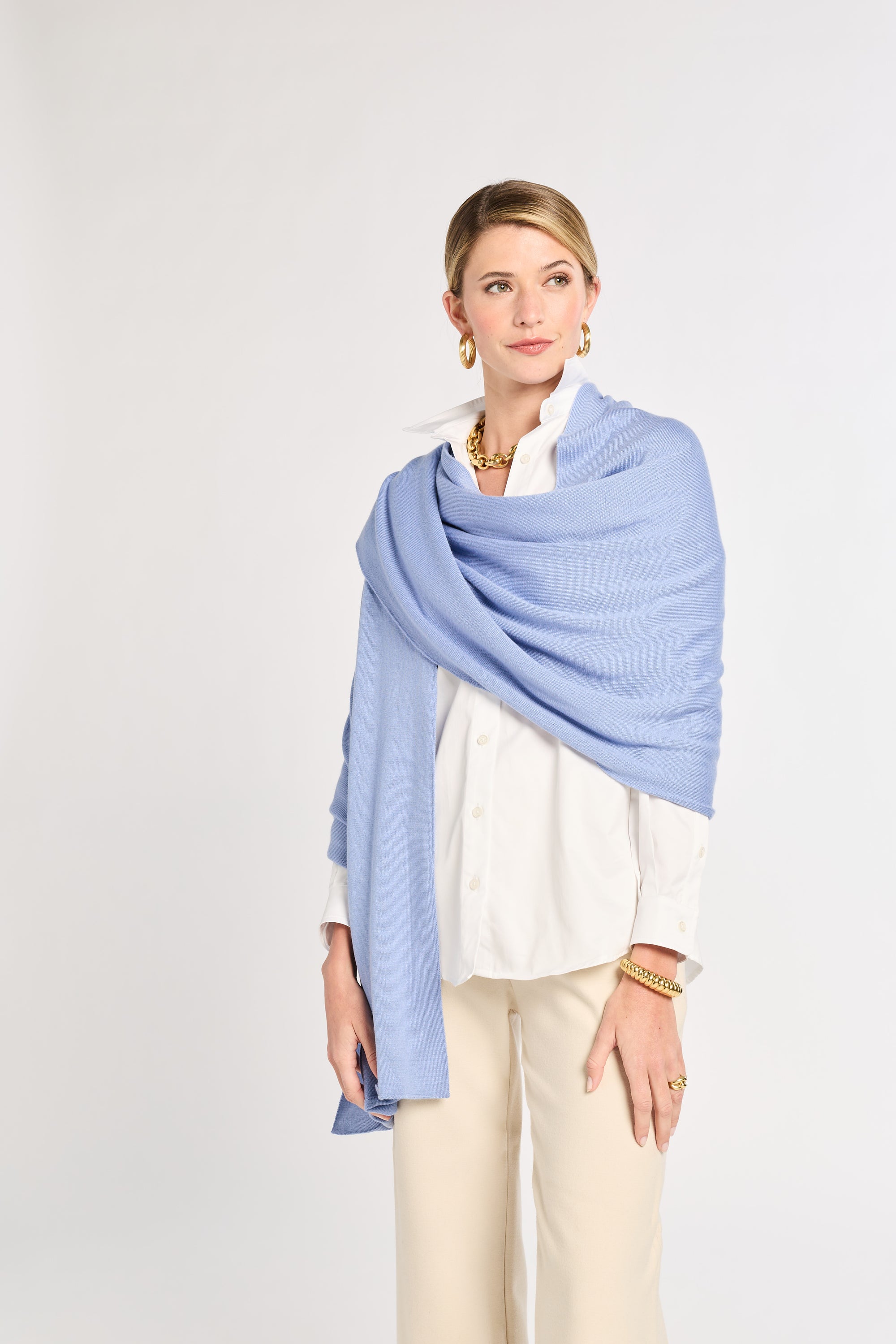Woman wearing a light blue scarf on a white background