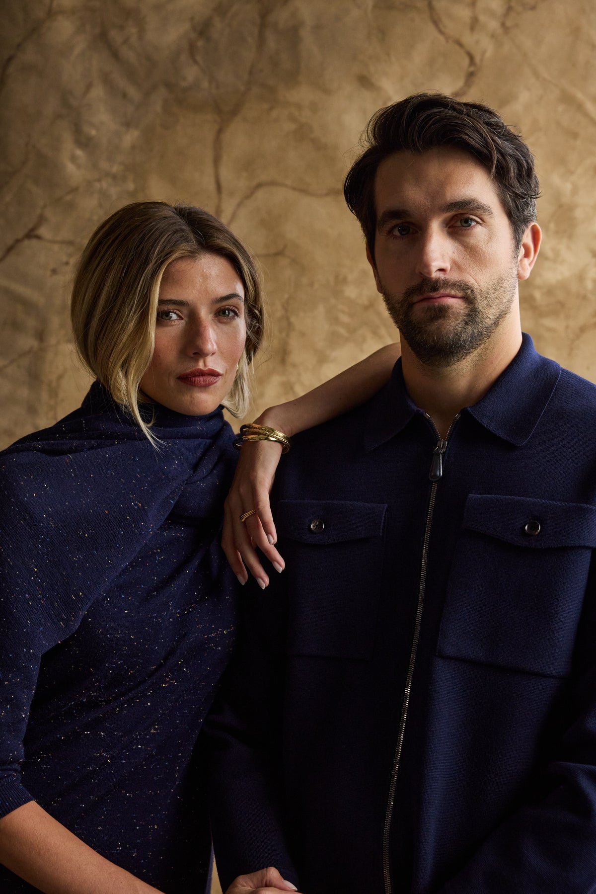 Woman and man standing together in blue cashmere outfits