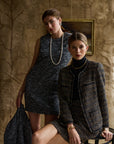 Women modeling tweed outfits with a tan background