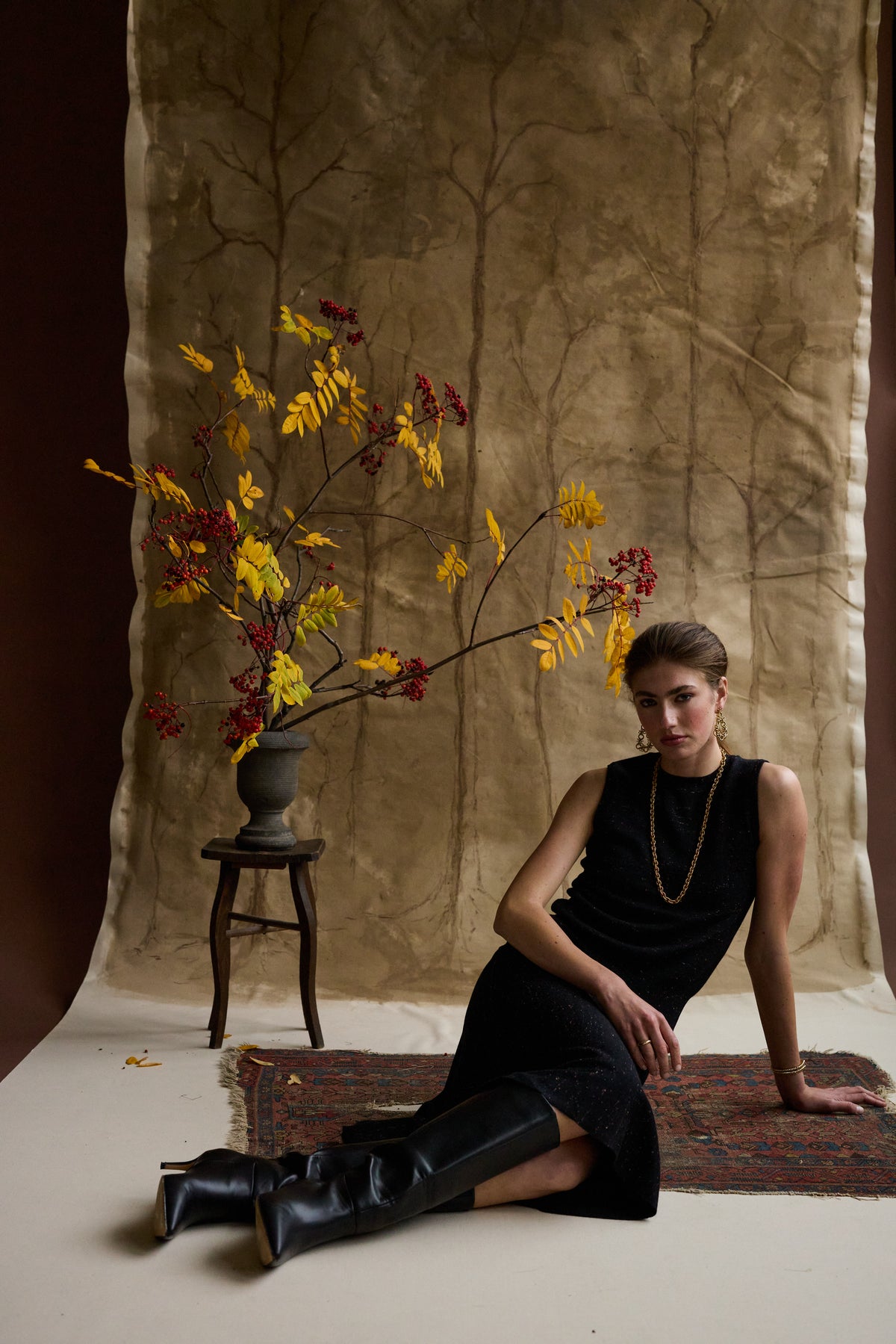Woman sitting down in a black flared skirt and shell