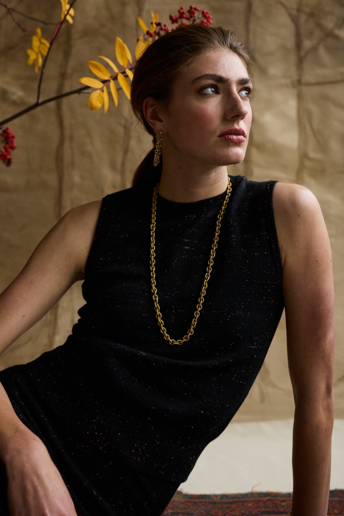Woman modeling a cashmere shell with a gold necklace
