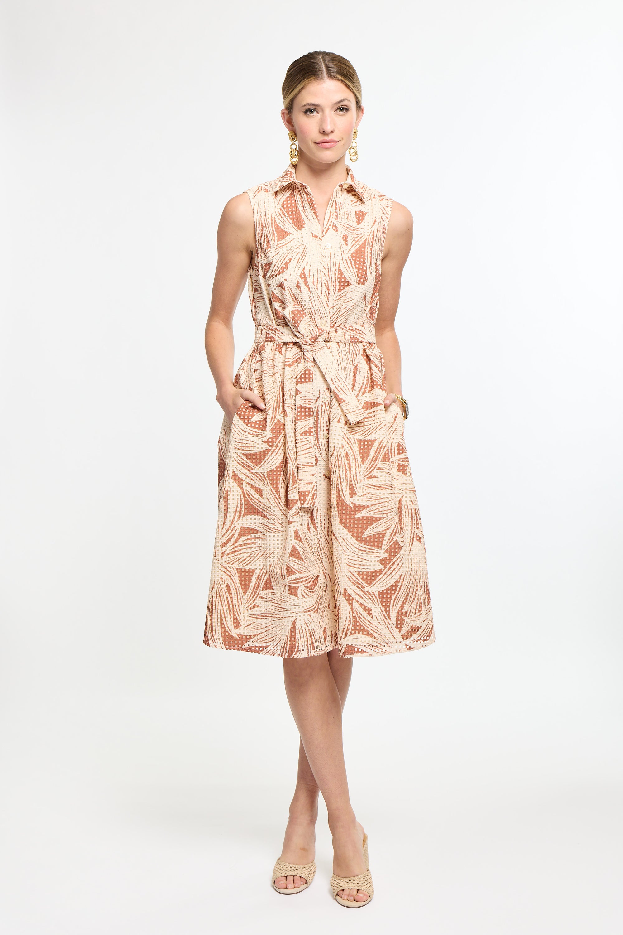 Woman wearing a patterned dress on a white background