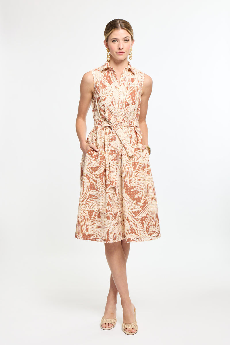 Woman wearing a patterned dress on a white background