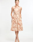 Woman wearing a patterned dress on a white background