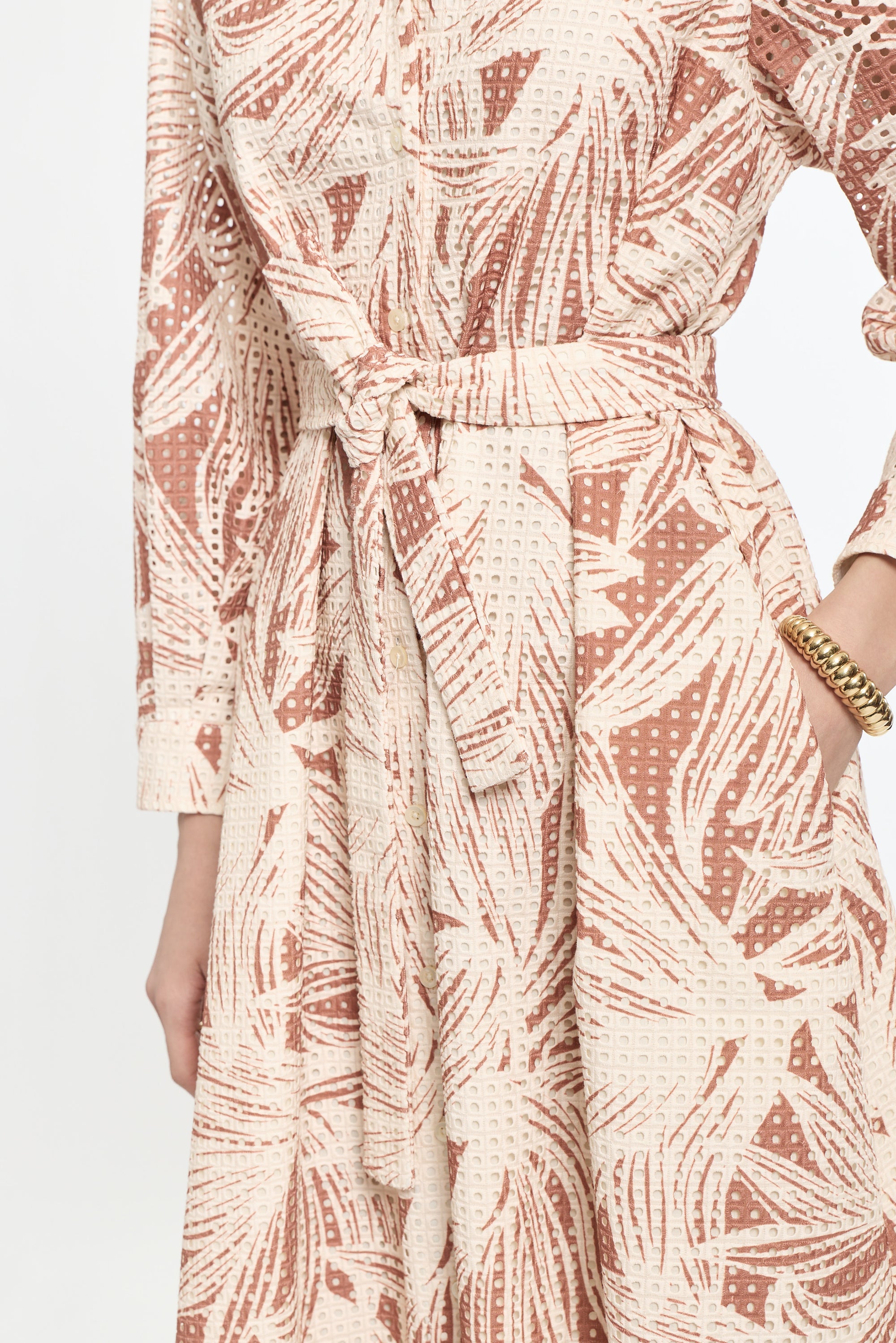 Patterned dress with a belt on a white background