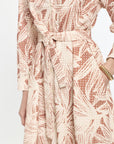 Patterned dress with a belt on a white background
