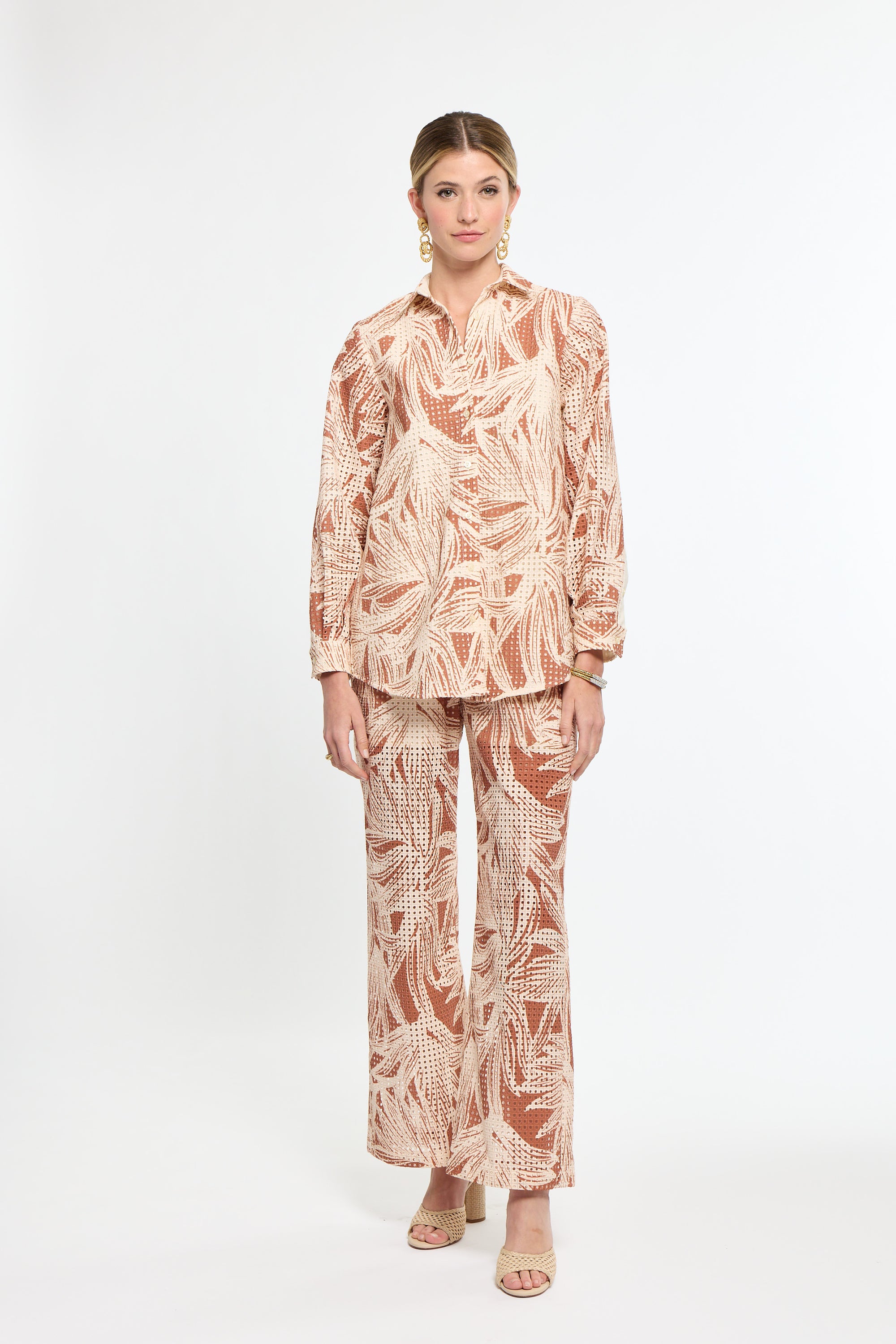 Woman wearing a patterned outfit on a white background