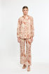 Woman wearing a patterned outfit on a white background