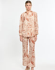 Woman wearing a patterned outfit on a white background