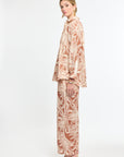Woman wearing a patterned outfit on a white background