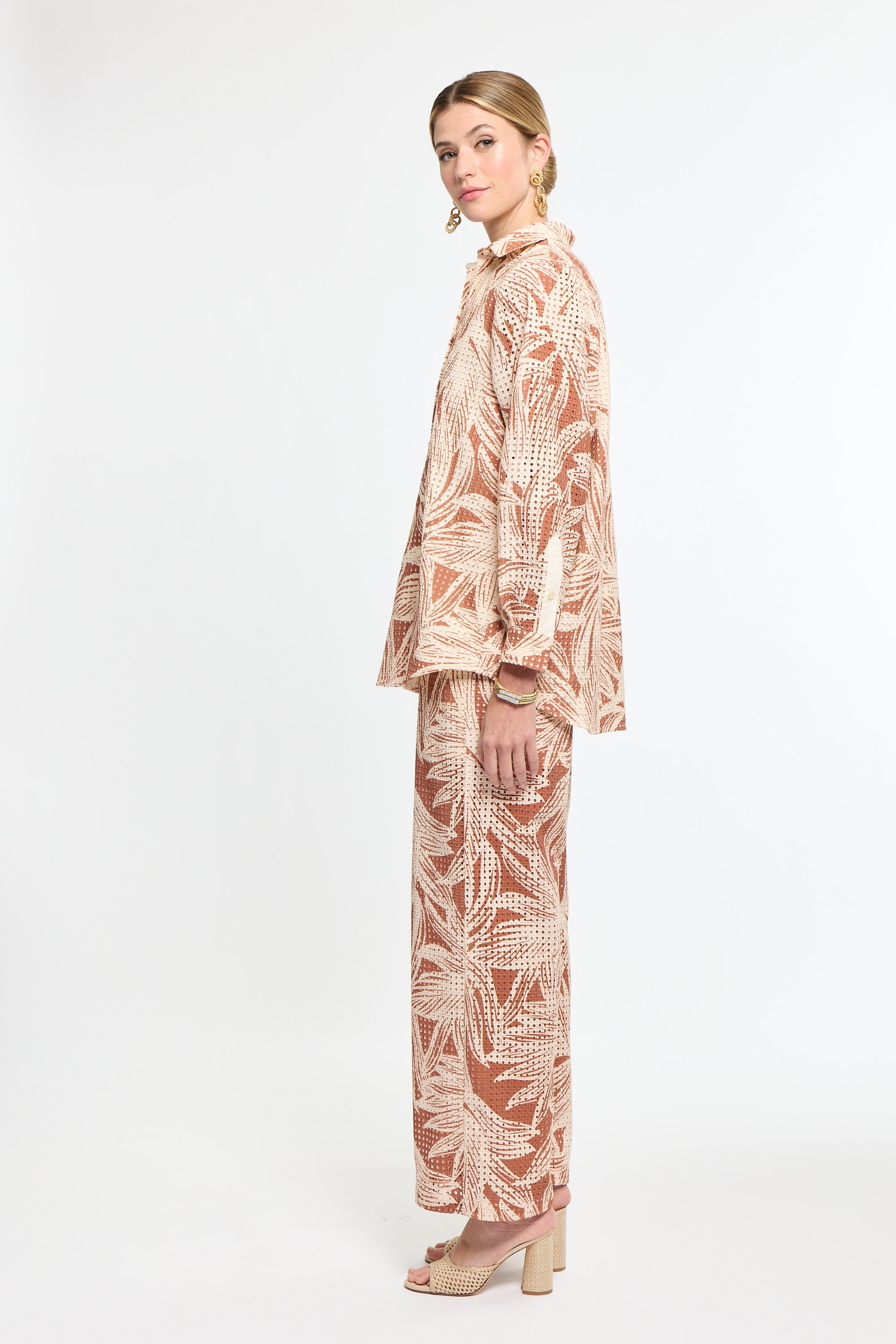 Woman wearing a patterned outfit on a white background