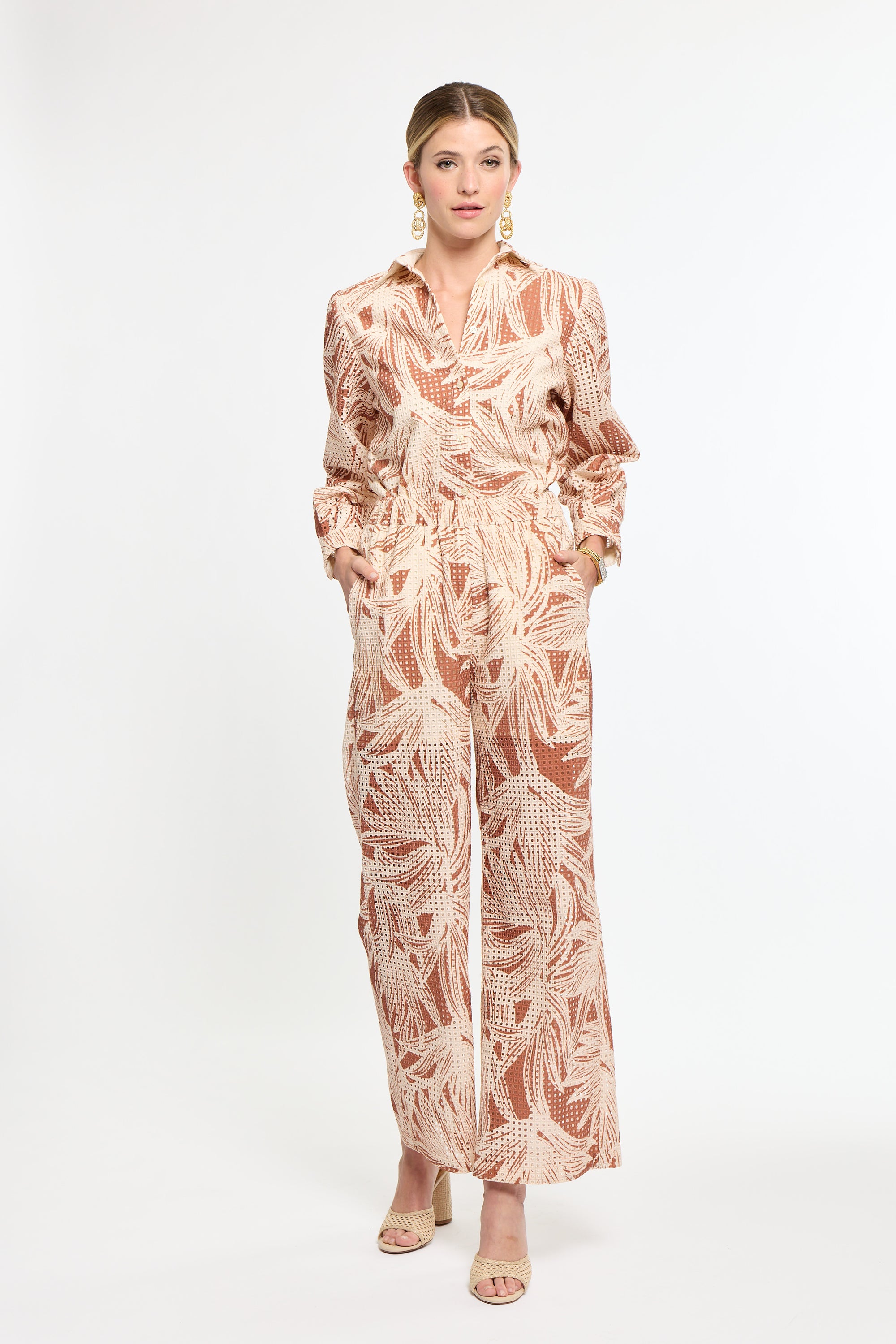 Woman wearing a patterned outfit on a white background
