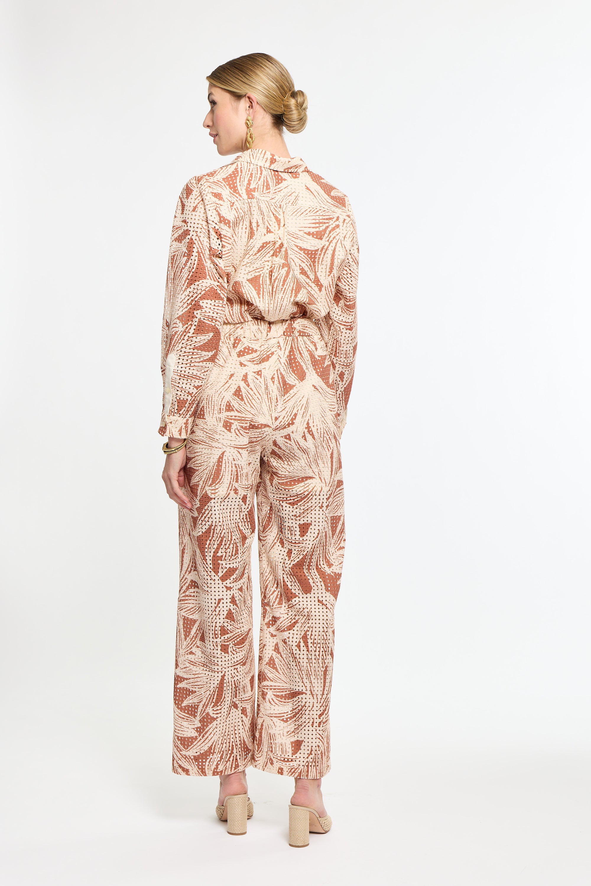 Woman wearing a patterned outfit on a white background