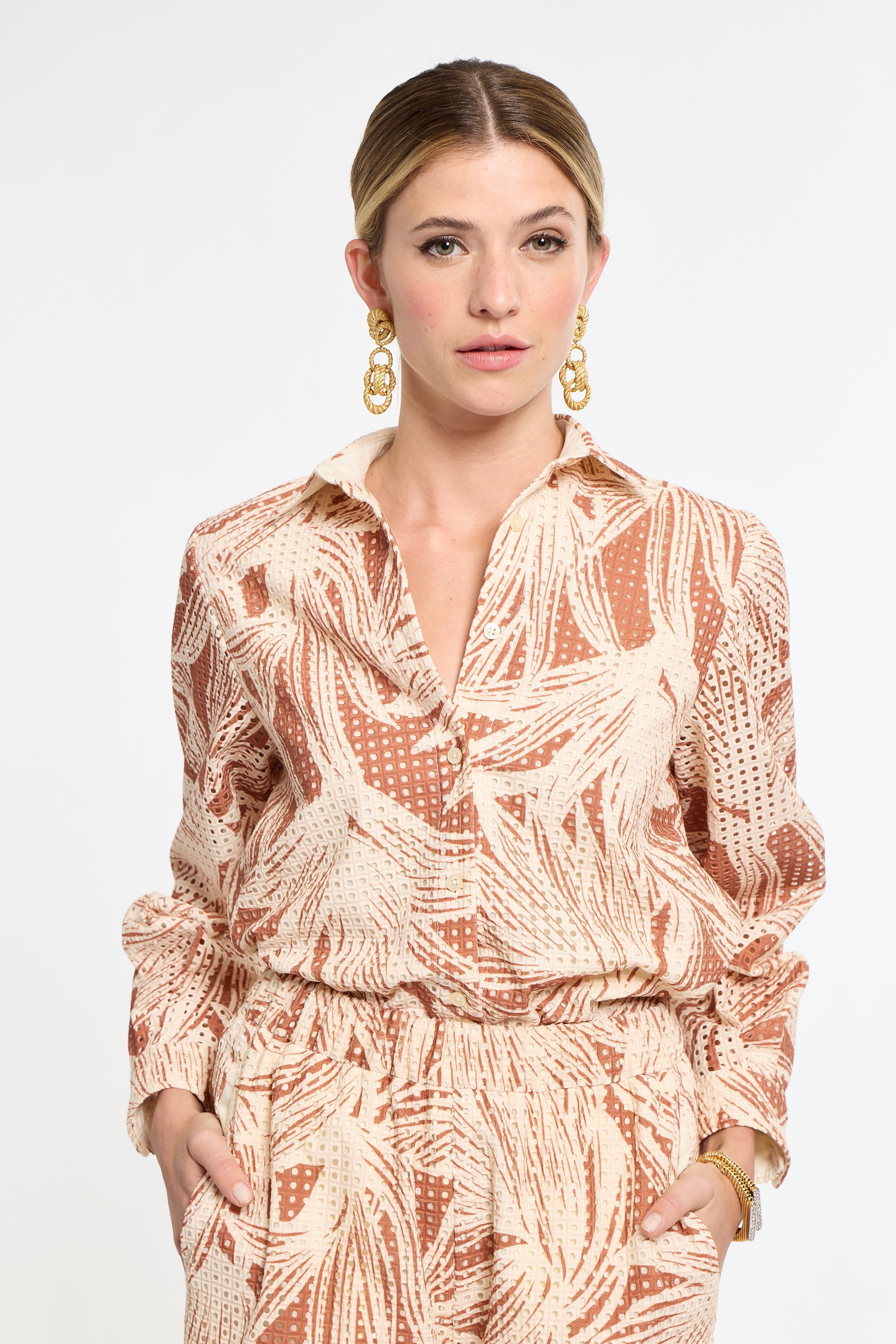 Woman wearing a patterned outfit on a white background