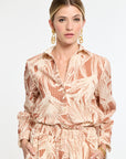 Woman wearing a patterned outfit on a white background