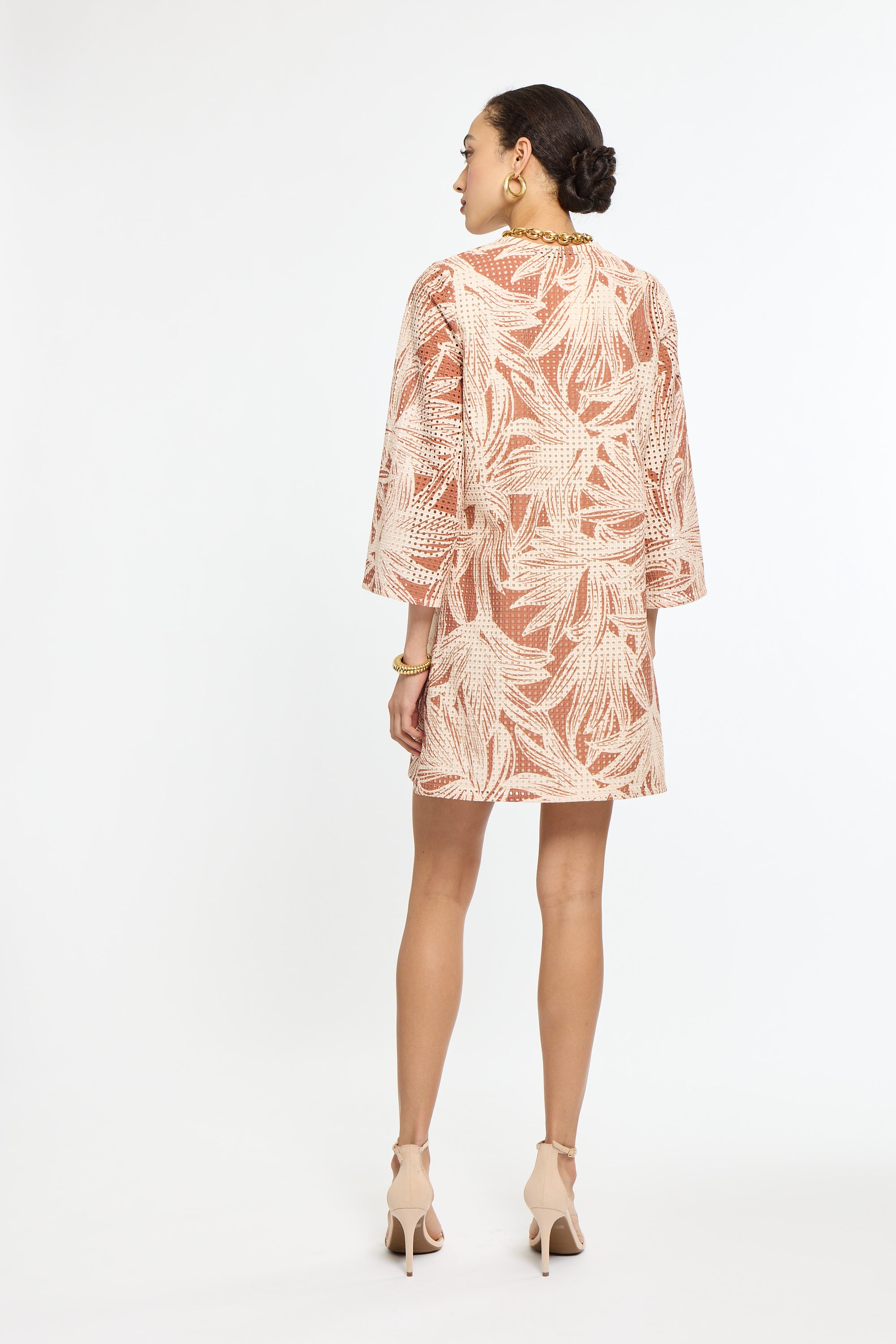 Woman wearing a floral dress on a white background