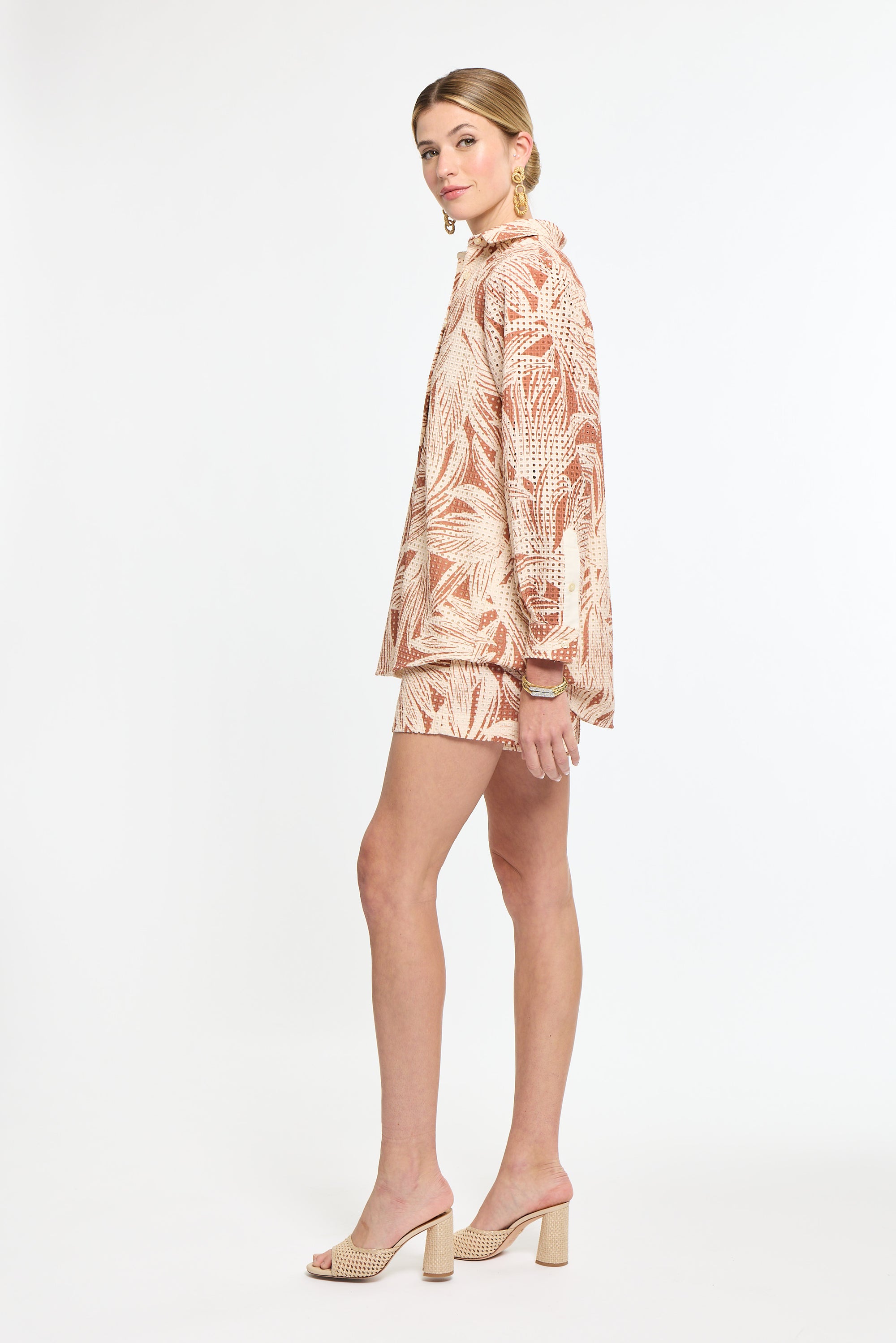 Woman wearing a patterned outfit on a white background