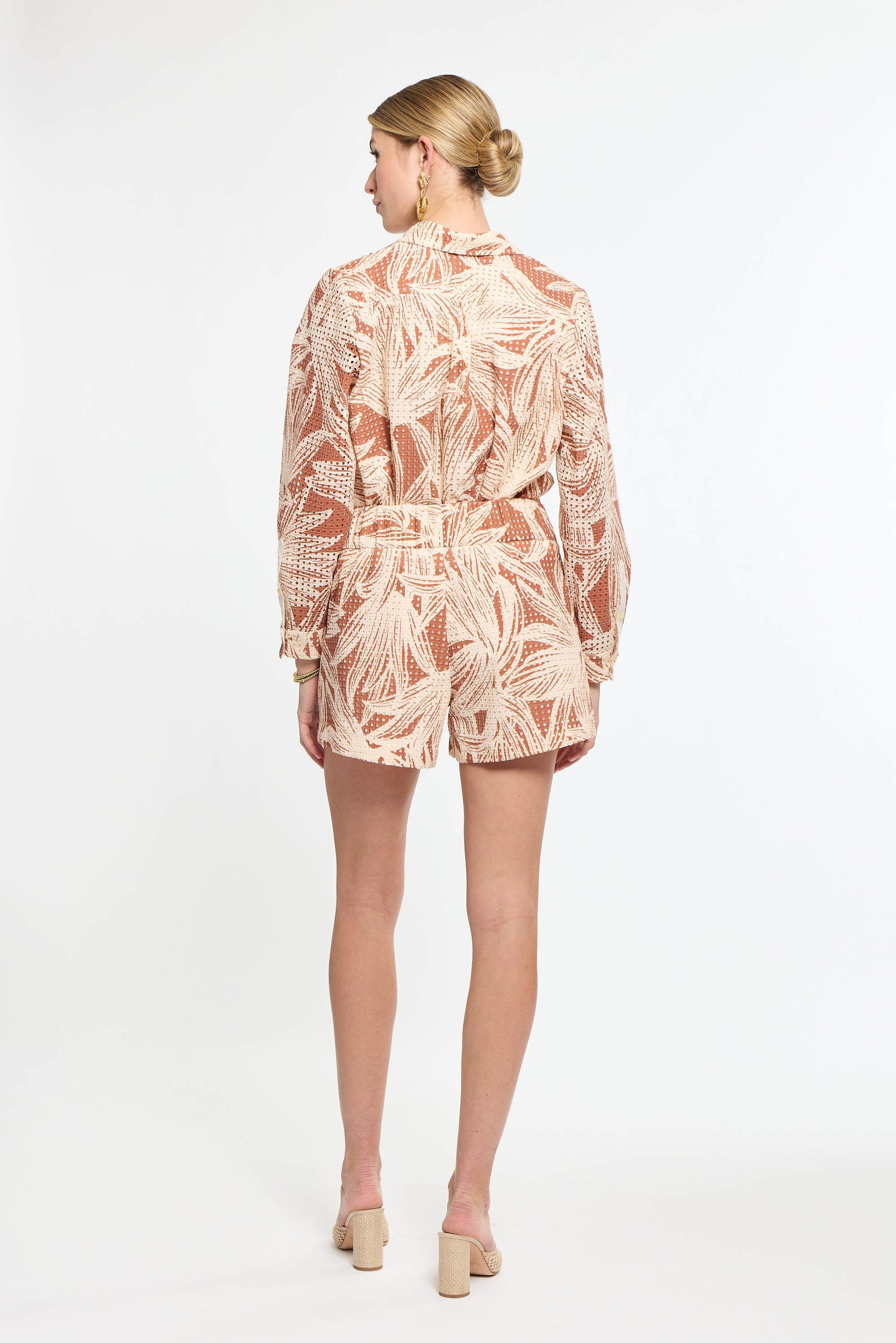 Woman wearing a patterned dress on a white background