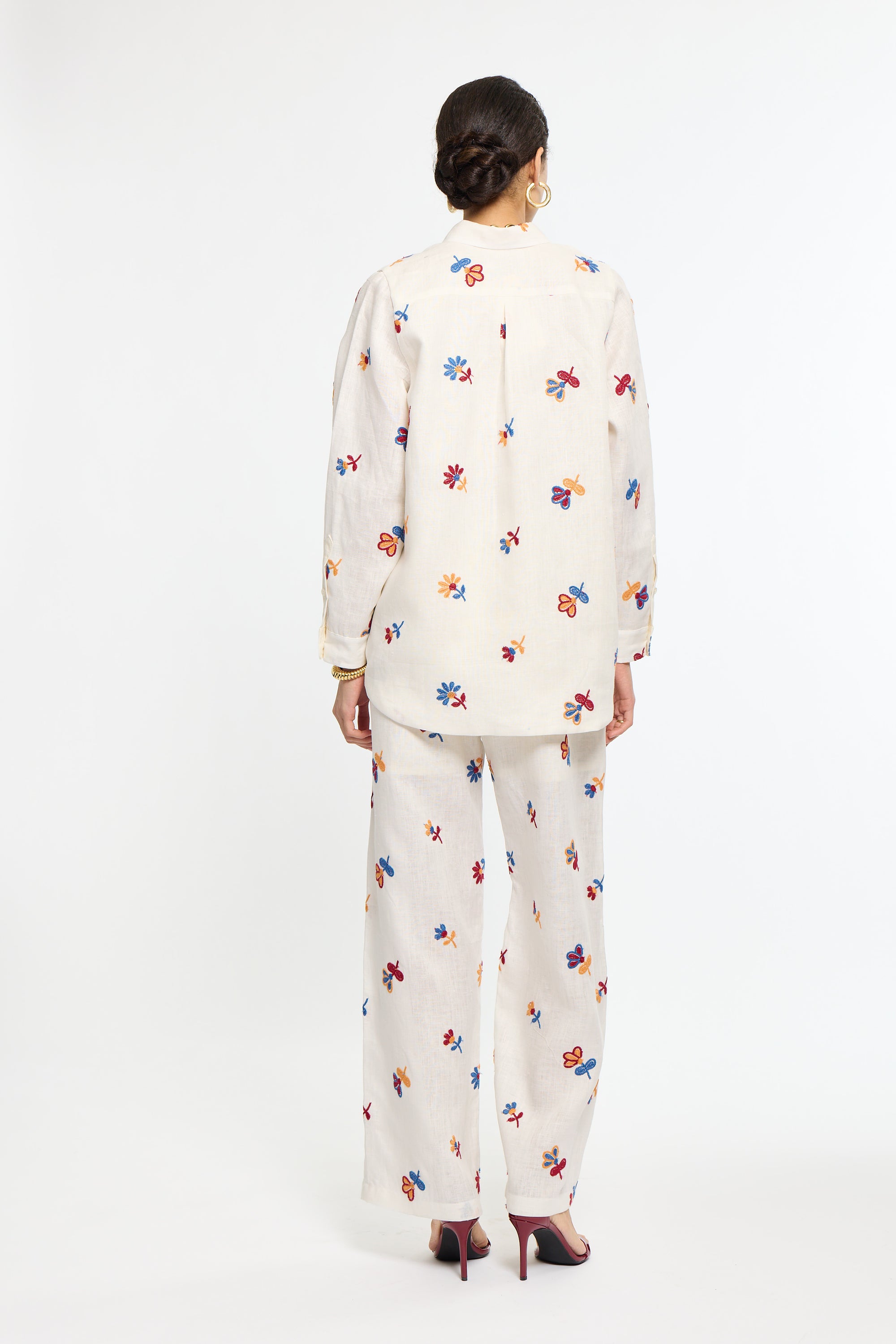 Person wearing a white floral outfit on a white background