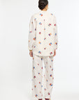 Person wearing a white floral outfit on a white background